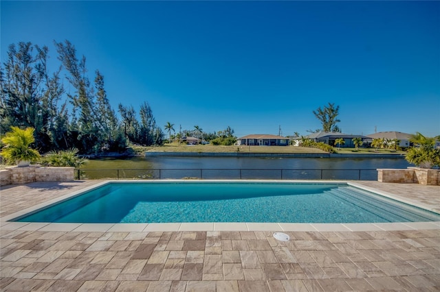 view of swimming pool with a patio area and a water view