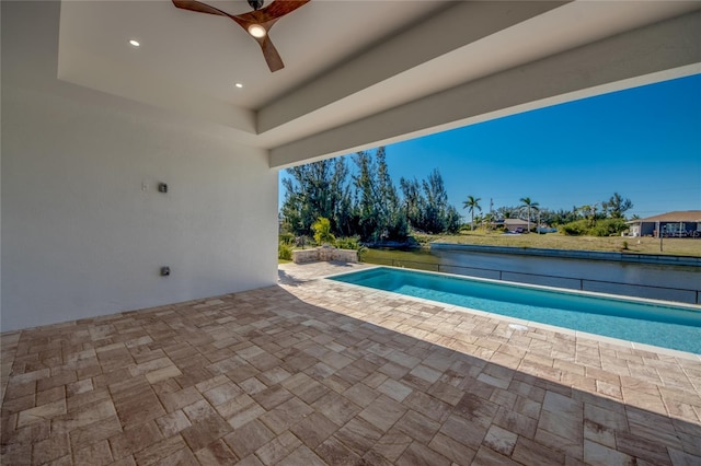 view of swimming pool with ceiling fan and a patio