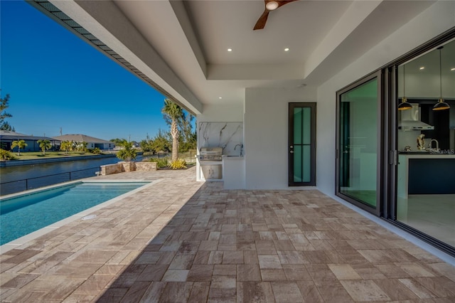 view of swimming pool featuring ceiling fan, a patio area, a grill, area for grilling, and a water view