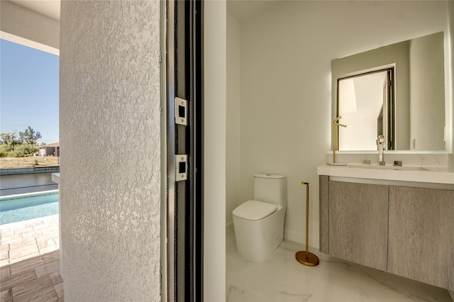 bathroom with toilet and vanity