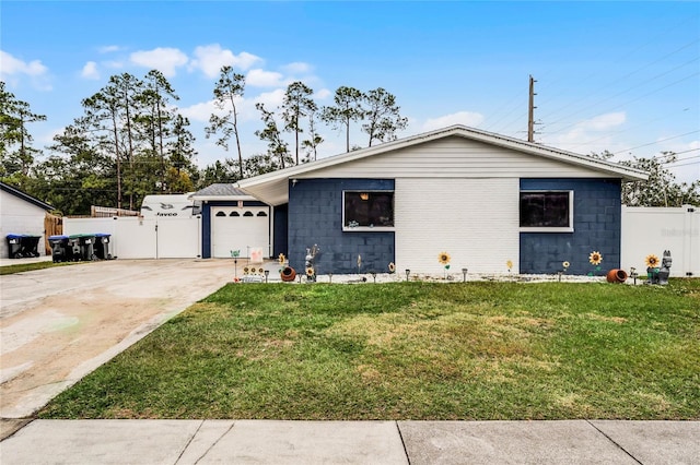 ranch-style house featuring a garage and a front lawn