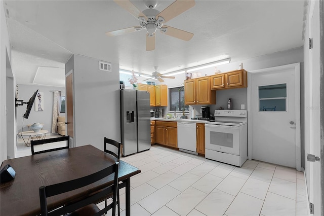 kitchen with sink, white appliances, and ceiling fan