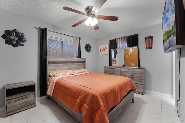 tiled bedroom featuring ceiling fan and a textured ceiling