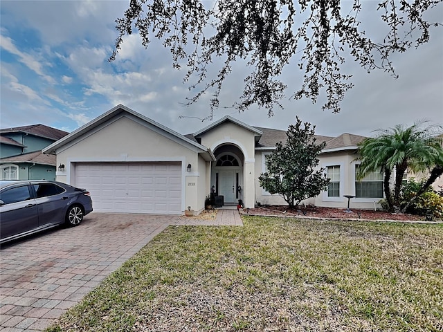 single story home featuring a front yard and a garage