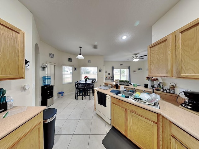 kitchen featuring dishwasher, light brown cabinets, hanging light fixtures, light tile patterned flooring, and ceiling fan