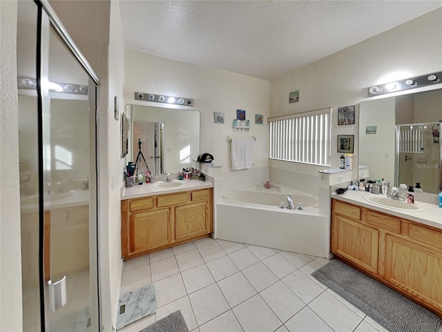 bathroom featuring a textured ceiling, tile patterned floors, vanity, and plus walk in shower