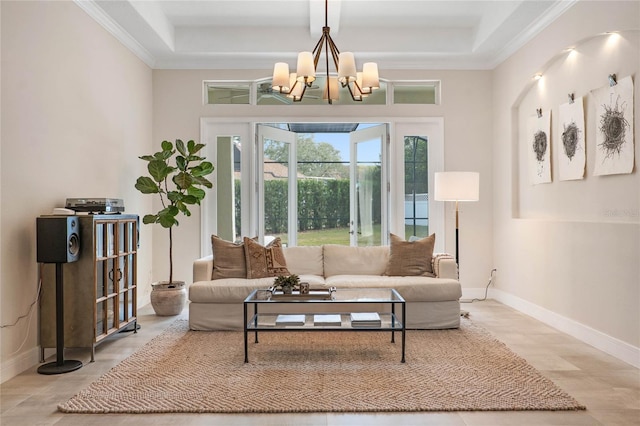 living room featuring light hardwood / wood-style flooring, crown molding, and an inviting chandelier