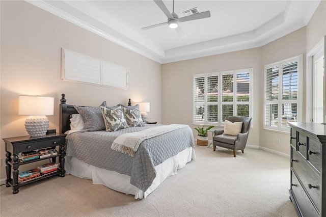 bedroom featuring light carpet, ceiling fan, and a raised ceiling