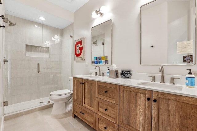 bathroom featuring walk in shower, vanity, tile patterned floors, and toilet