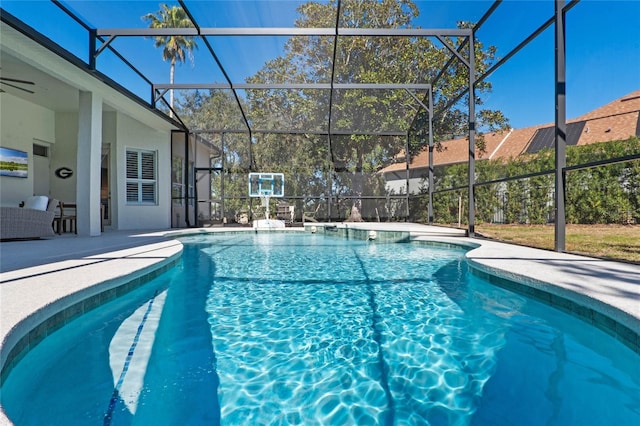 view of swimming pool featuring a lanai and a patio area