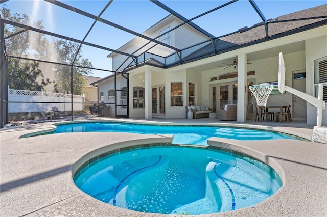 view of pool with a lanai, ceiling fan, a patio area, and outdoor lounge area