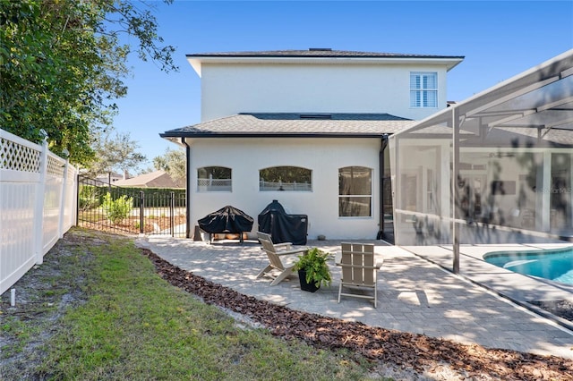 back of property with a lanai, a fenced in pool, and a patio