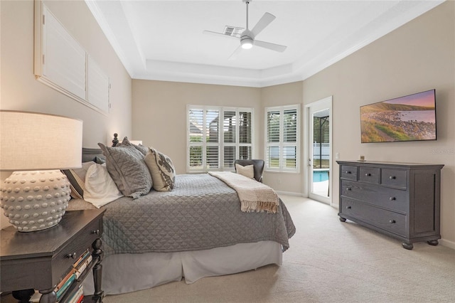 carpeted bedroom with a raised ceiling, access to outside, and ceiling fan