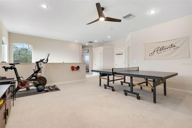 recreation room with ceiling fan and light colored carpet