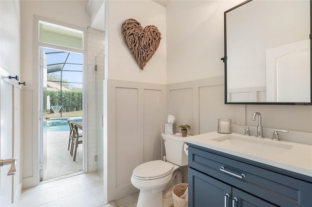 bathroom with walk in shower, vanity, toilet, and tile patterned flooring