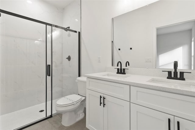 bathroom with vanity, toilet, and a shower with shower door