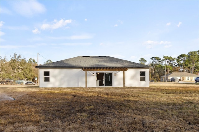 back of house with a lawn