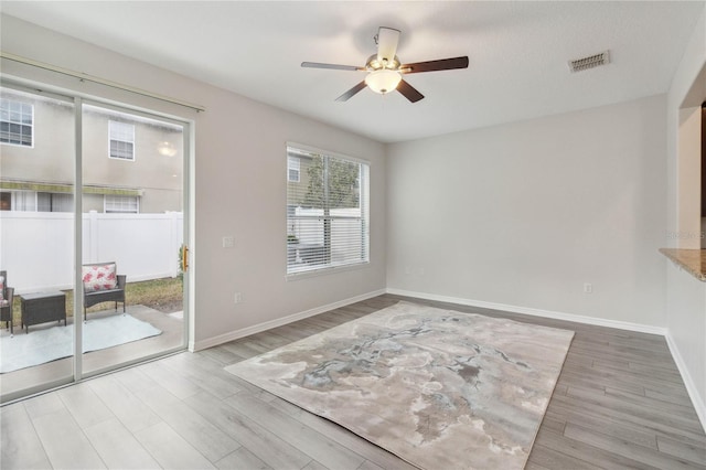 spare room featuring ceiling fan and light hardwood / wood-style flooring