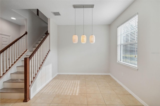 stairs with tile patterned floors