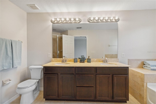 full bathroom with tile patterned flooring, vanity, shower with separate bathtub, and toilet