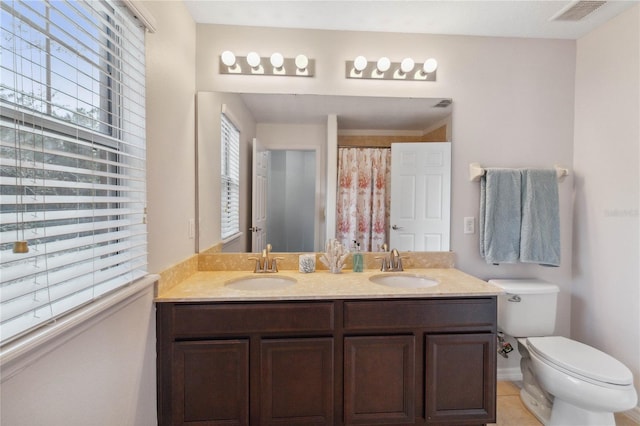 bathroom with vanity, tile patterned floors, and toilet