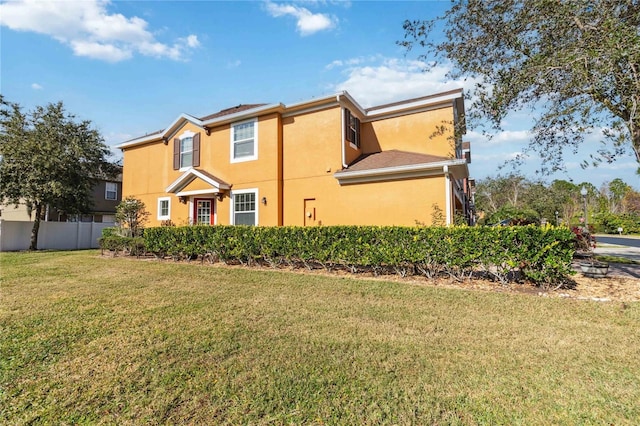 view of side of home with a yard