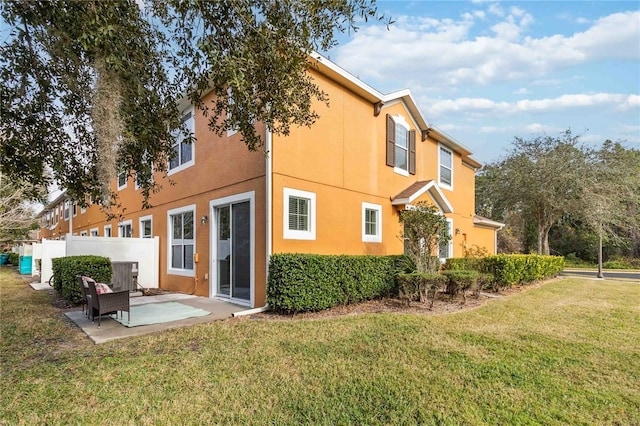 rear view of house with a patio, a yard, and central air condition unit