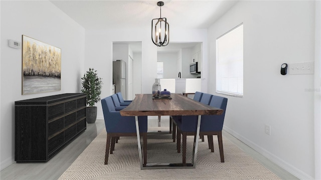 dining room featuring hardwood / wood-style floors and an inviting chandelier