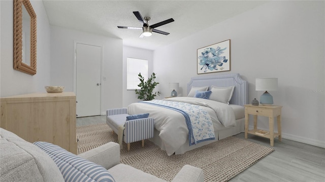 bedroom featuring ceiling fan, a textured ceiling, and light hardwood / wood-style flooring