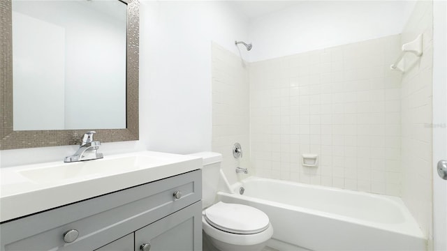 full bathroom with toilet, tiled shower / bath, and vanity