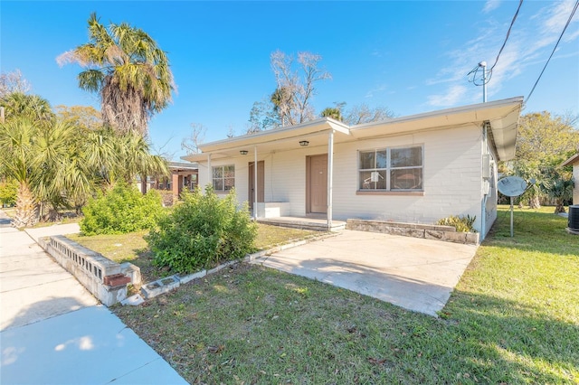 ranch-style home with central AC and a front lawn