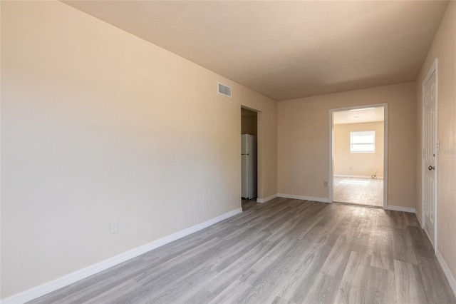 unfurnished room featuring light hardwood / wood-style flooring