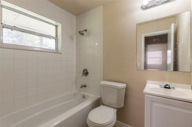 full bathroom with vanity, tiled shower / bath, and toilet