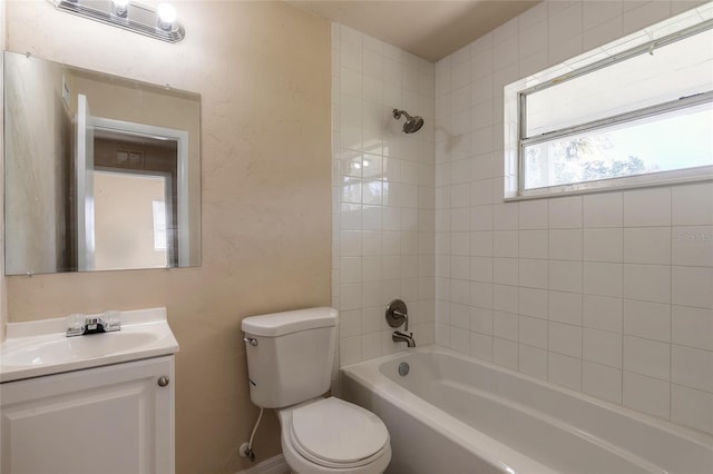 full bathroom with vanity, toilet, and tiled shower / bath