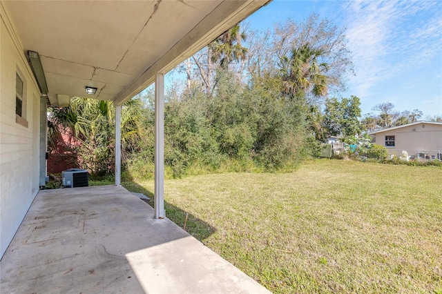 view of yard with central AC unit and a patio area