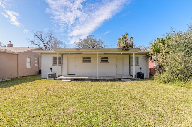 rear view of house featuring a yard, central AC, and a patio