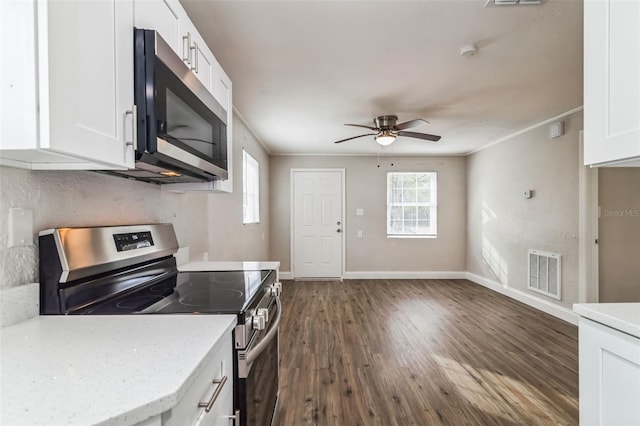 kitchen with appliances with stainless steel finishes, white cabinetry, and ornamental molding