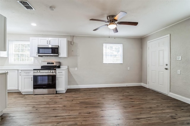 kitchen with dark wood-type flooring, white cabinetry, and stainless steel appliances