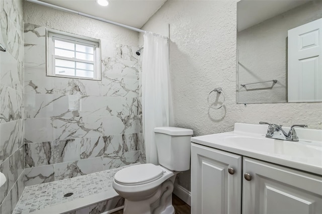 bathroom featuring curtained shower, toilet, and vanity