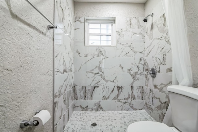 bathroom with toilet and a shower with shower curtain