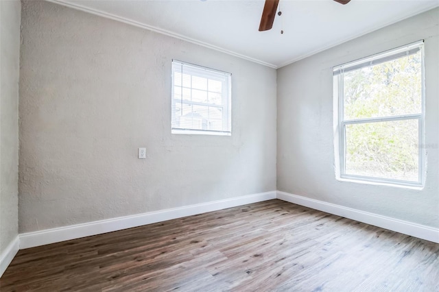 spare room featuring ceiling fan, hardwood / wood-style floors, and ornamental molding