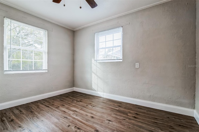 spare room with ceiling fan, plenty of natural light, crown molding, and hardwood / wood-style floors