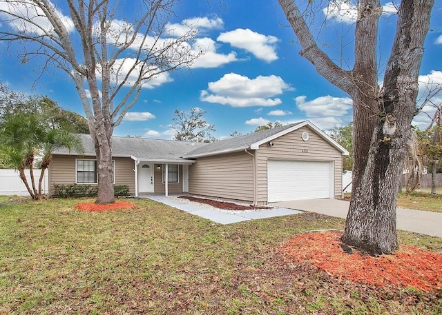 single story home featuring a garage and a front lawn