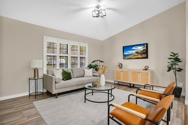 living room featuring hardwood / wood-style flooring and lofted ceiling