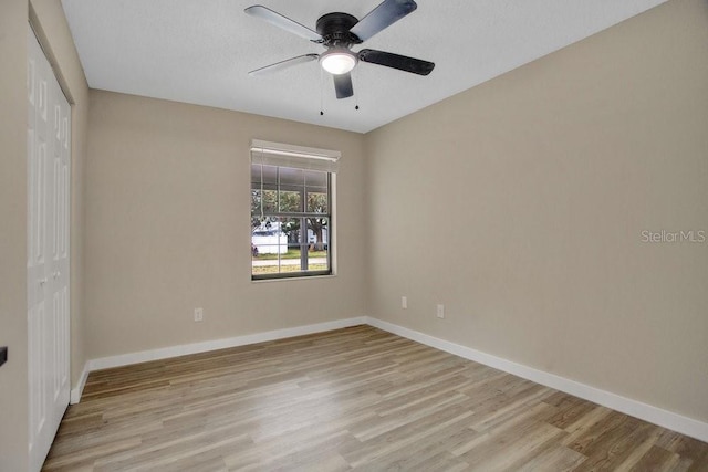 empty room with light hardwood / wood-style floors and ceiling fan