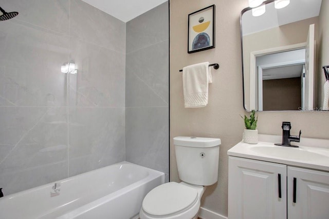 full bathroom featuring tiled shower / bath, vanity, and toilet