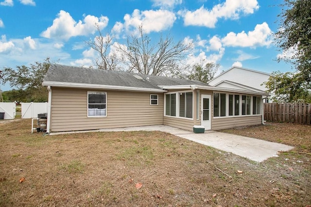 back of property featuring a sunroom, a yard, and a patio