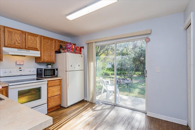 kitchen featuring white appliances and light hardwood / wood-style floors