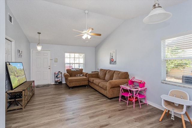 living room with hardwood / wood-style flooring, lofted ceiling, and ceiling fan