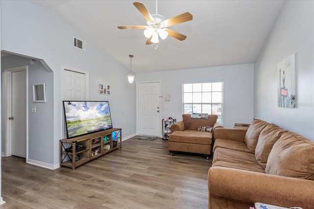 living room featuring hardwood / wood-style flooring, high vaulted ceiling, and ceiling fan